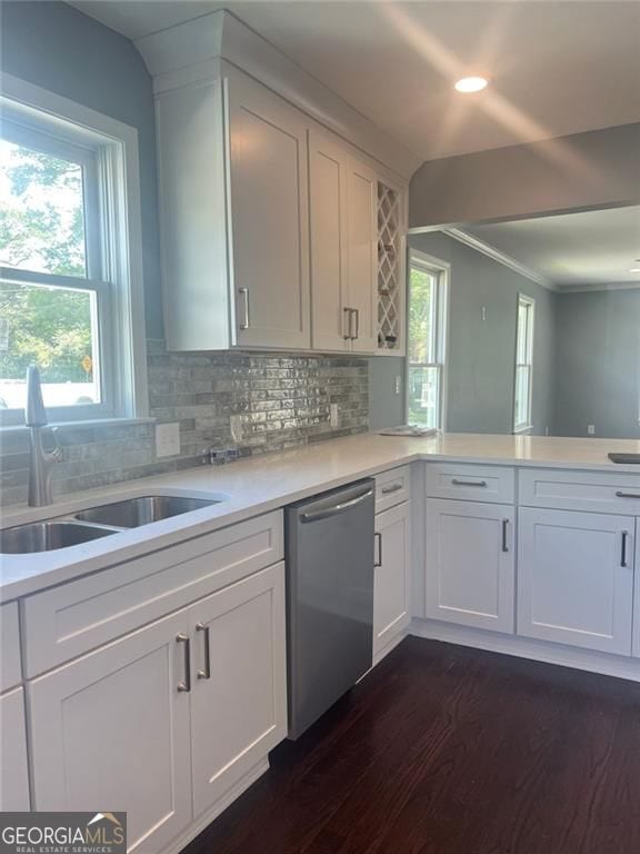 kitchen with stainless steel dishwasher, a sink, dark wood finished floors, healthy amount of natural light, and recessed lighting
