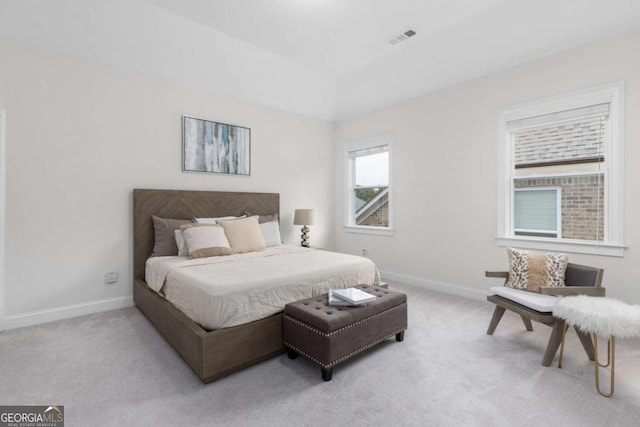 bedroom with baseboards, light carpet, and visible vents