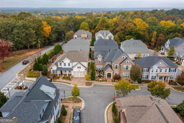 drone / aerial view with a residential view and a wooded view