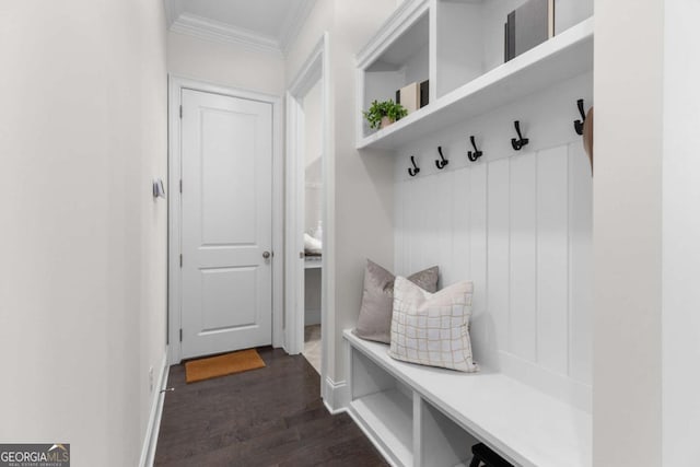 mudroom with crown molding, dark wood-style flooring, and baseboards