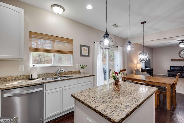 kitchen with open floor plan, dark wood finished floors, a sink, and dishwasher