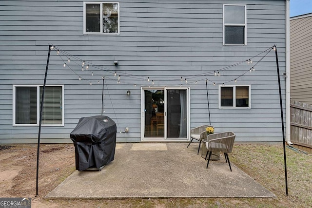 rear view of property with fence and a patio