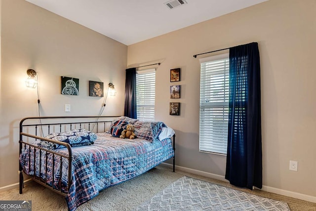carpeted bedroom with baseboards and visible vents