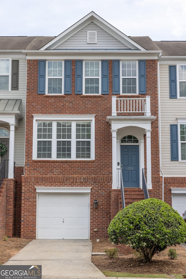 1306 Thornborough Dr Unit 1306, Alpharetta, GA 30004 - view of front of home with a garage, concrete driveway, and brick siding