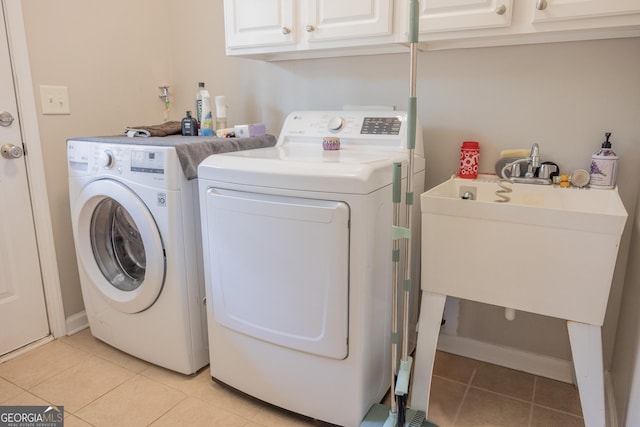 1306 Thornborough Dr Unit 1306, Alpharetta, GA 30004 - washroom with washing machine and clothes dryer, light tile patterned floors, and cabinet space