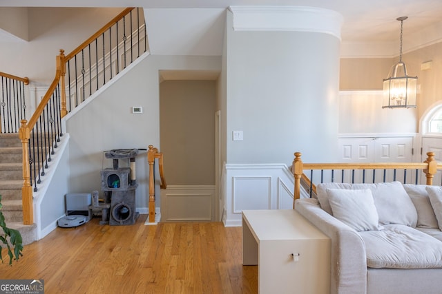 1306 Thornborough Dr Unit 1306, Alpharetta, GA 30004 - living area with light wood-style floors, a chandelier, wainscoting, and a decorative wall