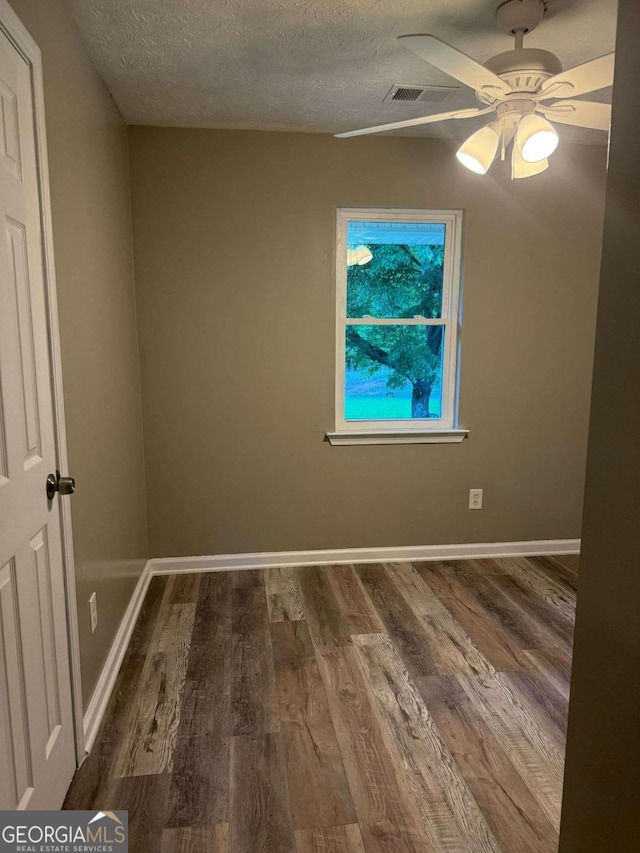 184 Quail Rd, Griffin, GA 30223 - empty room with baseboards, a ceiling fan, a textured ceiling, and wood finished floors