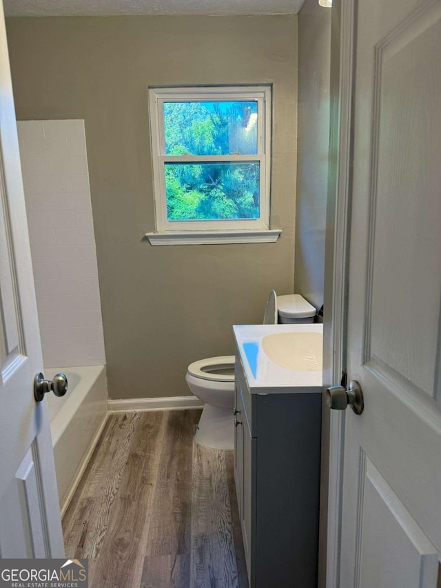184 Quail Rd, Griffin, GA 30223 - bathroom with vanity, baseboards, wood finished floors, and toilet