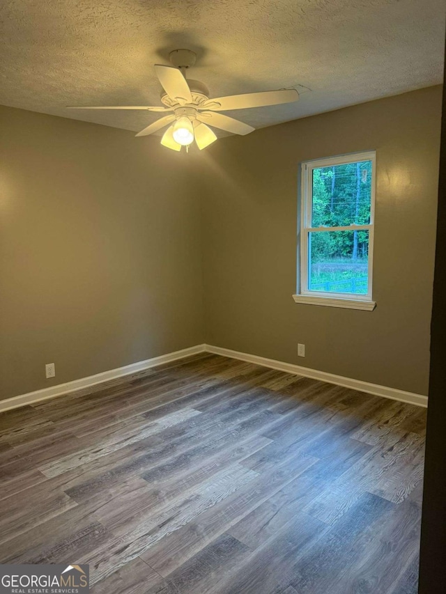 184 Quail Rd, Griffin, GA 30223 - spare room featuring baseboards, a textured ceiling, and dark wood-type flooring