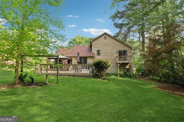 back of house with a lawn and a wooden deck