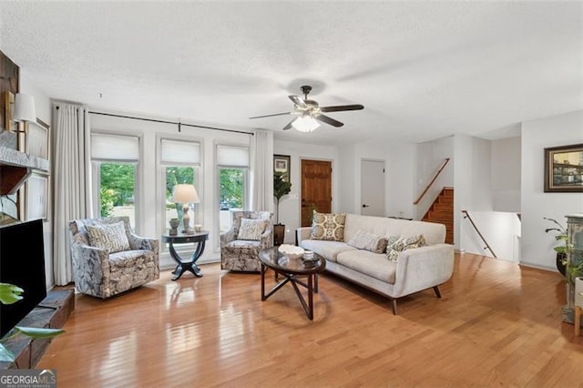 1149 Midland NW, Acworth, GA 30102 - living room featuring light wood finished floors, ceiling fan, and stairway