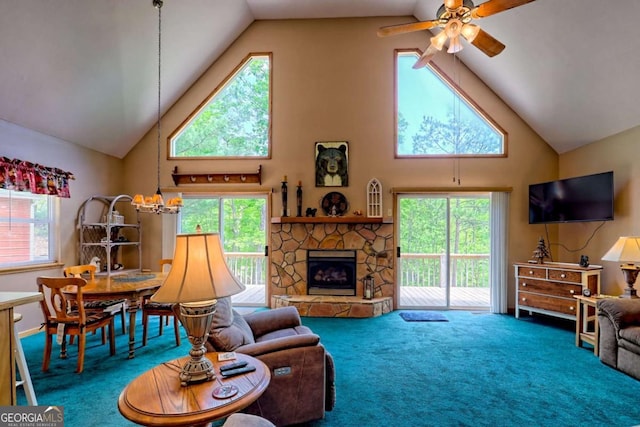 carpeted living room with a healthy amount of sunlight, high vaulted ceiling, and a ceiling fan