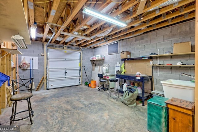 garage featuring concrete block wall and a workshop area
