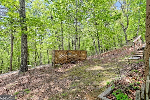 view of yard featuring stairs and a forest view