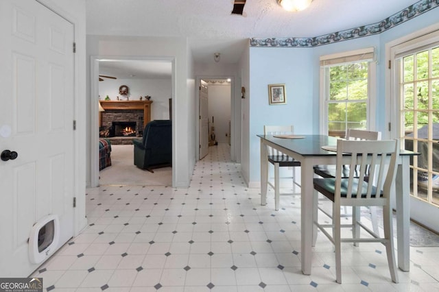 569 Hale Mountain Ct, Hiram, GA 30141 - dining area featuring baseboards, light floors, and a fireplace