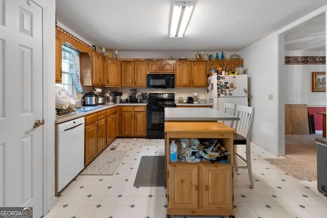 569 Hale Mountain Ct, Hiram, GA 30141 - kitchen with brown cabinetry, light countertops, light floors, and black appliances