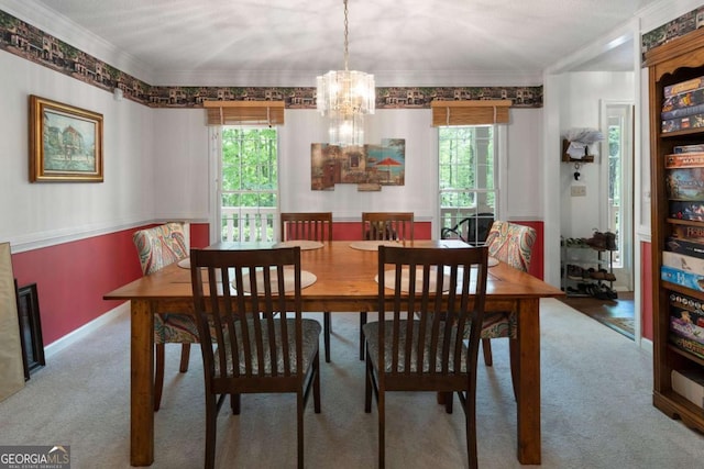 569 Hale Mountain Ct, Hiram, GA 30141 - dining area with crown molding, a chandelier, a healthy amount of sunlight, and carpet