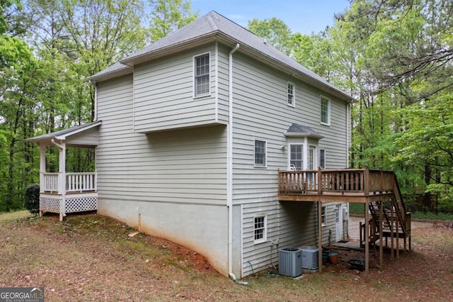 569 Hale Mountain Ct, Hiram, GA 30141 - rear view of house with central air condition unit, a deck, and stairs