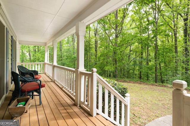 569 Hale Mountain Ct, Hiram, GA 30141 - wooden terrace featuring a porch and a wooded view