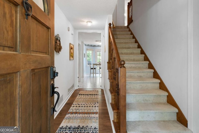569 Hale Mountain Ct, Hiram, GA 30141 - foyer entrance with baseboards, visible vents, dark wood-style floors, and stairway