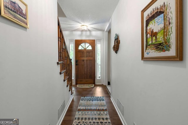 569 Hale Mountain Ct, Hiram, GA 30141 - entryway with visible vents, a textured ceiling, dark wood finished floors, and stairway