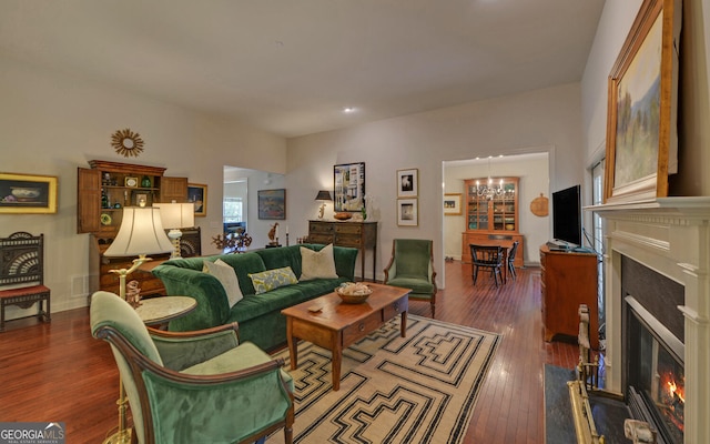922 Brenau Point Dr, Gainesville, GA 30501 - living area featuring a notable chandelier, a glass covered fireplace, recessed lighting, visible vents, and dark wood-style floors