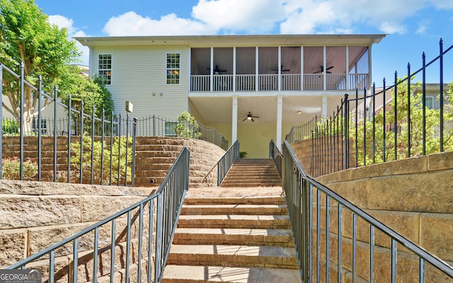 922 Brenau Point Dr, Gainesville, GA 30501 - back of house featuring stairs, ceiling fan, fence, and a sunroom