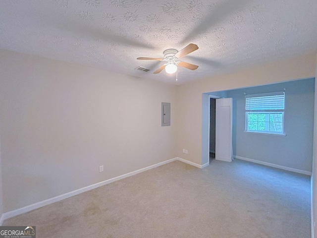 unfurnished bedroom with a textured ceiling, visible vents, baseboards, and electric panel