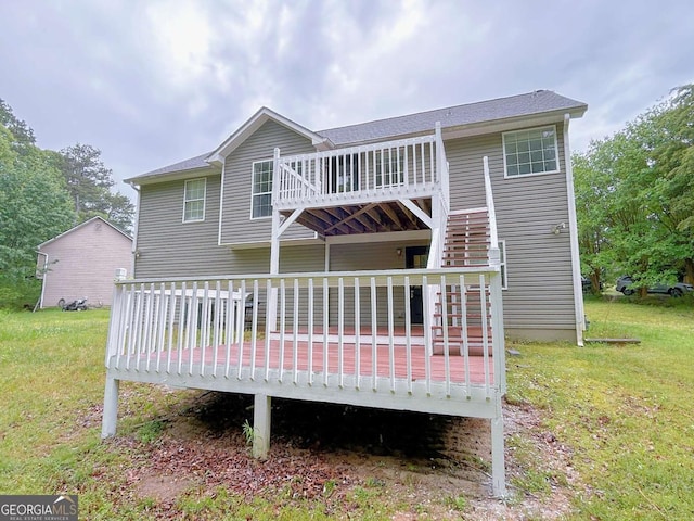 rear view of property with a lawn and a wooden deck