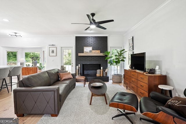109 Old Virginia Cir, Jonesboro, GA 30236 - living area featuring a ceiling fan, ornamental molding, a fireplace, and light wood-style flooring