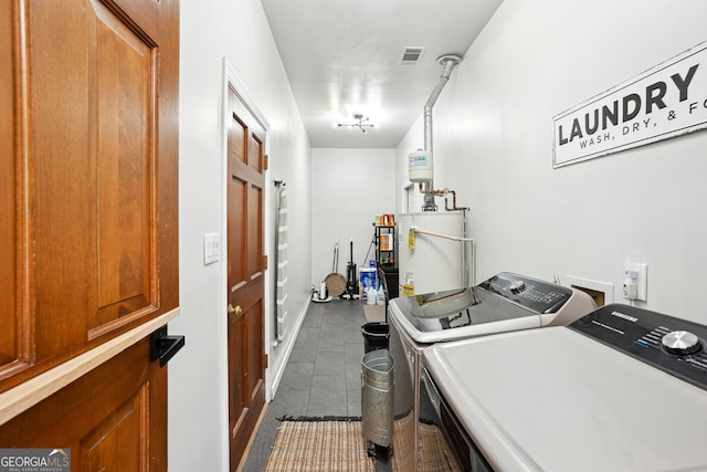 109 Old Virginia Cir, Jonesboro, GA 30236 - laundry room featuring washer and clothes dryer, water heater, and dark tile patterned flooring