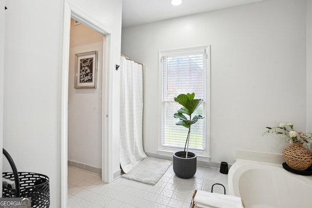 109 Old Virginia Cir, Jonesboro, GA 30236 - full bath featuring plenty of natural light, tile patterned flooring, curtained shower, and baseboards