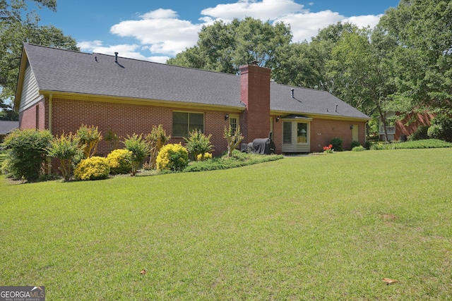 109 Old Virginia Cir, Jonesboro, GA 30236 - back of property with brick siding, a yard, a chimney, and roof with shingles