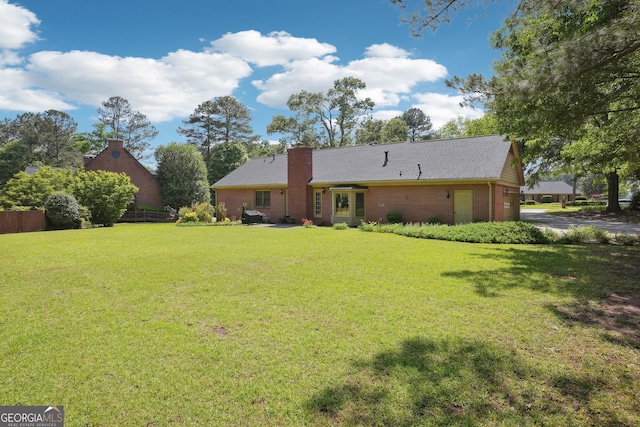 109 Old Virginia Cir, Jonesboro, GA 30236 - rear view of house with a yard, a chimney, brick siding, and driveway