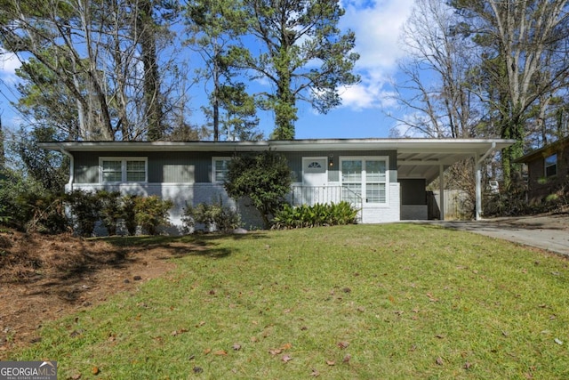 ranch-style house with brick siding, driveway, a front yard, and a carport
