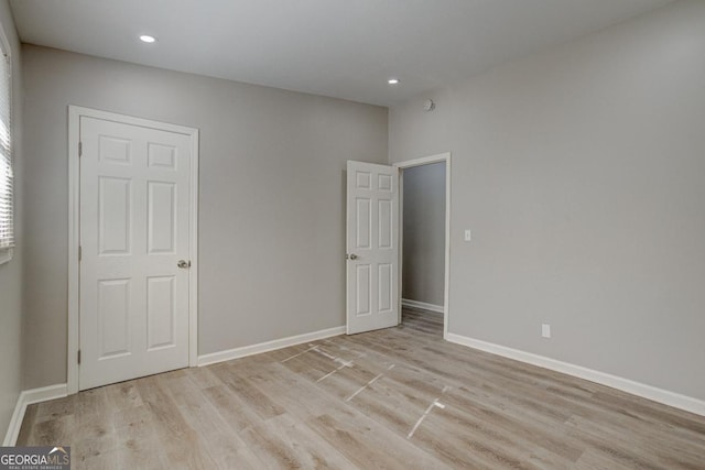 unfurnished bedroom with baseboards, recessed lighting, and light wood-style flooring
