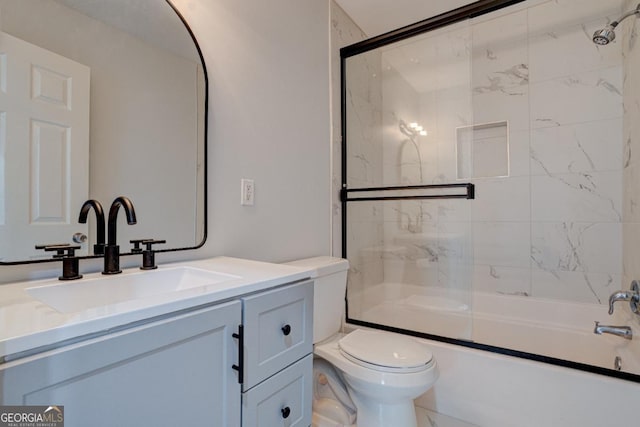 full bathroom with vanity, combined bath / shower with glass door, and toilet