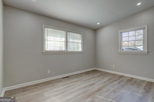 unfurnished room featuring recessed lighting, baseboards, visible vents, and light wood finished floors