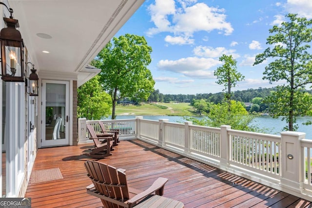 wooden terrace featuring a water view