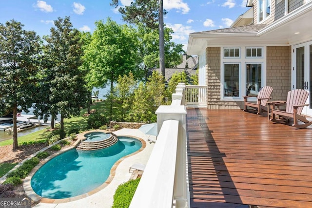 view of pool featuring a pool with connected hot tub and a wooden deck