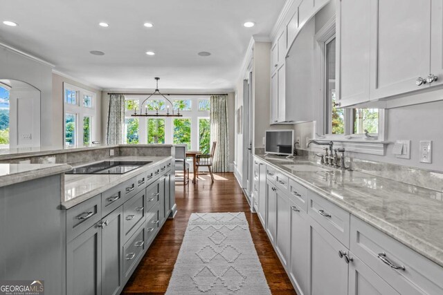 kitchen featuring a sink, plenty of natural light, and black electric stovetop