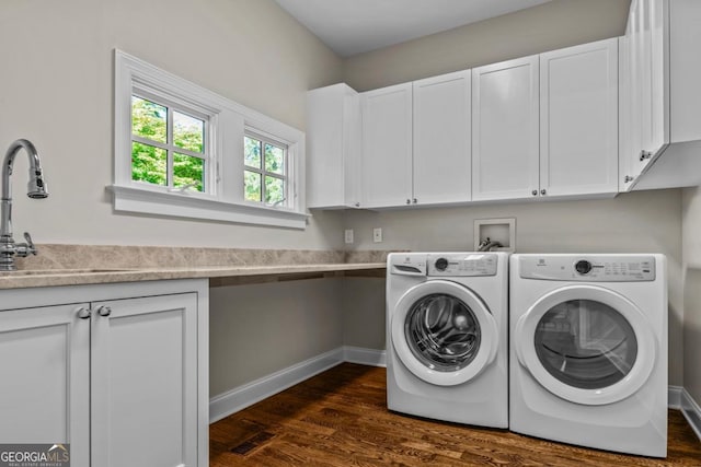laundry room with cabinet space, separate washer and dryer, a sink, and dark wood-type flooring