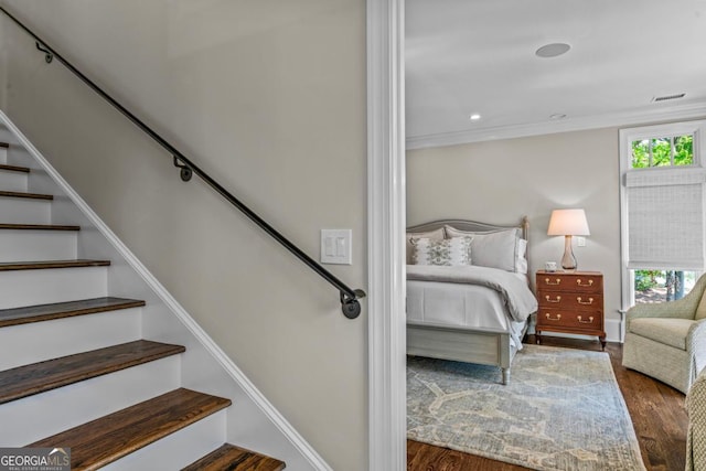 interior space with baseboards, wood finished floors, and visible vents