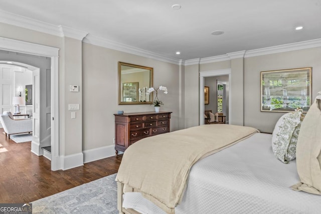 bedroom featuring crown molding, arched walkways, recessed lighting, baseboards, and dark wood-type flooring
