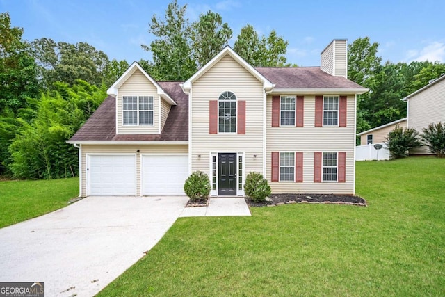 view of front of house with an attached garage, driveway, a chimney, and a front lawn