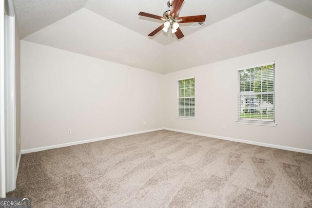 empty room featuring carpet floors, a ceiling fan, and baseboards