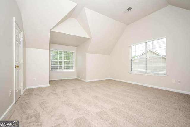 bonus room with baseboards, carpet flooring, and vaulted ceiling