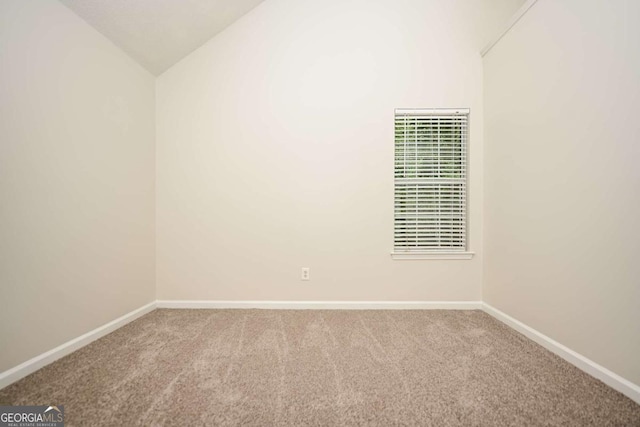 carpeted empty room with baseboards, lofted ceiling, and a heating unit