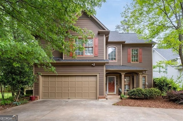 traditional-style home featuring a garage and driveway