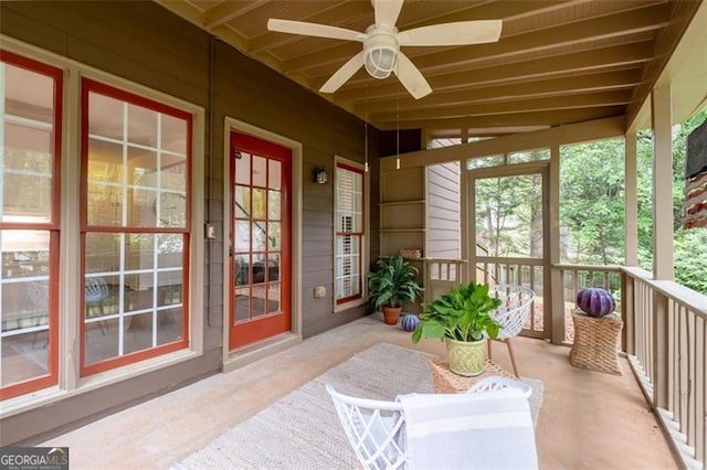 sunroom / solarium featuring ceiling fan